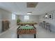 Finished basement boasts a pool table, foosball, bar seating, and a stylish design at 8431 Magnolia Dr, Jonesboro, GA 30238