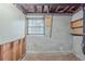 Unfinished basement, cinder block walls, window, and exposed ceiling at 8431 Magnolia Dr, Jonesboro, GA 30238