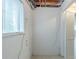 Unfinished basement shows bare walls, utilities and window at 8431 Magnolia Dr, Jonesboro, GA 30238