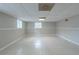 Unfinished basement space with tiled flooring, natural light, and paneled walls at 8431 Magnolia Dr, Jonesboro, GA 30238