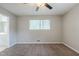 This bedroom features neutral walls, carpet flooring, a ceiling fan and a window at 8431 Magnolia Dr, Jonesboro, GA 30238