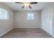 This bedroom features neutral walls, carpet flooring, two windows and a closet at 8431 Magnolia Dr, Jonesboro, GA 30238
