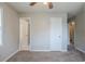 This bedroom features neutral walls, carpet flooring, and multiple doors to different rooms at 8431 Magnolia Dr, Jonesboro, GA 30238