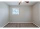This bedroom features neutral walls, carpet flooring, a window and a ceiling fan at 8431 Magnolia Dr, Jonesboro, GA 30238