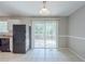 Bright dining area with a sliding glass door leading to the deck, featuring tiled floors and ample natural light at 8431 Magnolia Dr, Jonesboro, GA 30238