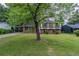 Traditional split-level home with well-kept lawn and mature trees in a quiet neighborhood at 8431 Magnolia Dr, Jonesboro, GA 30238