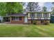 Charming split-level home featuring a well-maintained lawn and traditional brick and siding accents at 8431 Magnolia Dr, Jonesboro, GA 30238