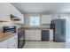 Well-lit kitchen featuring white cabinets, black appliances, and a window offering ample natural light at 8431 Magnolia Dr, Jonesboro, GA 30238