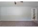 Spacious living room with neutral walls, plush carpet, and an open doorway leading to the stairs at 8431 Magnolia Dr, Jonesboro, GA 30238