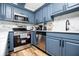 This kitchen features modern appliances, light blue cabinets, and a stainless steel oven at 277 Clearview Ct, Villa Rica, GA 30180
