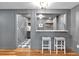 Home bar area features a stylish design with a unique backsplash and sink with barstool seating at 3265 Belmont Glen Se Dr, Marietta, GA 30067