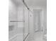 Shower and tub featuring white marble wall, glass enclosure and stainless steel hardware at 3265 Belmont Glen Se Dr, Marietta, GA 30067