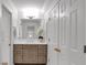 Bathroom featuring a sink with an oversized mirror and a set of white cabinets to the side at 3265 Belmont Glen Se Dr, Marietta, GA 30067
