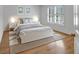 Bedroom featuring hardwood floors, a large window, and soft, neutral-colored decor at 3265 Belmont Glen Se Dr, Marietta, GA 30067