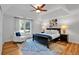 Spacious bedroom showcasing hardwood floors, a tray ceiling, and ample natural light at 3265 Belmont Glen Se Dr, Marietta, GA 30067