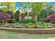 Entrance to Belmont, featuring a brick sign, manicured bushes and colorful flowers at 3265 Belmont Glen Se Dr, Marietta, GA 30067