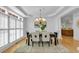 Bright dining room with windows, modern light fixture, table and seating for six at 3265 Belmont Glen Se Dr, Marietta, GA 30067