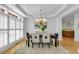 Bright dining room with windows, modern light fixture, table and seating for six at 3265 Belmont Glen Se Dr, Marietta, GA 30067