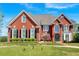 Stately red brick home with manicured lawn and mature landscaping at 3265 Belmont Glen Se Dr, Marietta, GA 30067