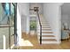 Bright foyer with hardwood floors, white staircase, and natural light at 3265 Belmont Glen Se Dr, Marietta, GA 30067