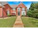 Attractive brick home featuring a lush lawn and a stone walkway leading to the front door at 3265 Belmont Glen Se Dr, Marietta, GA 30067