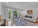 Bright living room featuring hardwood floors, modern decor, and large windows with backyard views at 3265 Belmont Glen Se Dr, Marietta, GA 30067