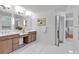 Bright main bathroom with dual vanities, a walk-in closet, and white marble tile at 3265 Belmont Glen Se Dr, Marietta, GA 30067