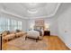 Bright main bedroom featuring a tray ceiling, plantation shutters, and hardwood floors at 3265 Belmont Glen Se Dr, Marietta, GA 30067
