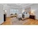 Serene main bedroom with tray ceiling, hardwood floors, and a seating area by the window at 3265 Belmont Glen Se Dr, Marietta, GA 30067
