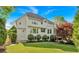 Rear exterior showcasing a spacious backyard, stone patio, and lush landscaping at 3265 Belmont Glen Se Dr, Marietta, GA 30067