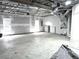 Spacious unfinished basement with visible ceiling beams and natural light from two windows at 4872 Lewis Rd, Powder Springs, GA 30127
