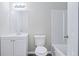 Bathroom featuring a toilet, white vanity, mirror, new fixtures, light gray walls, and a bathtub-shower at 4872 Lewis Rd, Powder Springs, GA 30127