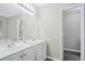 Clean bathroom featuring double sink vanity, light gray walls, and a large mirror with modern lighting at 4872 Lewis Rd, Powder Springs, GA 30127