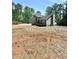 Exterior view of a home showcasing gray siding, a deck, chimney and a spacious lot at 4872 Lewis Rd, Powder Springs, GA 30127