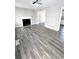 Bright living room featuring a fireplace, modern gray floors, light-colored walls, and recessed lighting at 4872 Lewis Rd, Powder Springs, GA 30127