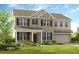 Charming two-story home with a manicured lawn, gray brick, a covered entry, and a two-car garage at 5240 Trescott Path, Cumming, GA 30028