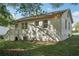 Back exterior of home with brick, stairs and large trees at 176 Nancy Se Dr, Marietta, GA 30067