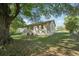 Rear exterior of house with brick, windows, and lush backyard with shade trees at 176 Nancy Se Dr, Marietta, GA 30067