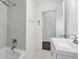 Bathroom features tub with gray subway tile, white vanity, and stylish fixtures at 176 Nancy Se Dr, Marietta, GA 30067