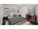 This bedroom features two windows and is furnished with a bed, side tables, and decor at 176 Nancy Se Dr, Marietta, GA 30067
