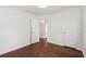 Clean bedroom with hardwood floors, white walls, closet and doorway at 176 Nancy Se Dr, Marietta, GA 30067
