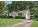 Charming traditional home with a well-manicured lawn and mature landscaping at 176 Nancy Se Dr, Marietta, GA 30067
