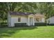 Traditional brick home with a neat, green lawn and manicured bushes at 176 Nancy Se Dr, Marietta, GA 30067