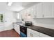Well-lit kitchen features white cabinets, dark countertops, and stainless steel appliances at 176 Nancy Se Dr, Marietta, GA 30067