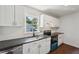 Well-lit kitchen featuring white cabinetry, dark countertops, and modern appliances at 176 Nancy Se Dr, Marietta, GA 30067