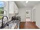Well-lit kitchen features updated sink and faucet, stainless steel appliances, and modern white cabinets at 176 Nancy Se Dr, Marietta, GA 30067