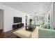 Inviting living room featuring light green furniture, modern decor, and wood floors at 176 Nancy Se Dr, Marietta, GA 30067
