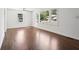 Sunlit living room features hardwood floors and large windows offering street views at 176 Nancy Se Dr, Marietta, GA 30067