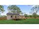 A spacious backyard featuring a wooden deck with seating, grassy lawn, and fenced perimeter, ideal for outdoor activities at 1835 Hawkins Se St, Smyrna, GA 30080