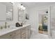 Bright bathroom featuring double sinks with gold hardware and a view to a bedroom at 1835 Hawkins Se St, Smyrna, GA 30080